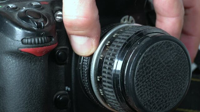 Close up of manual aperture opening up on photo camera lens - shutter speed control in professional reflex analog camera - learn photographic technique to take pictures