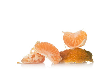 Tangerine slices on the skin on a white background