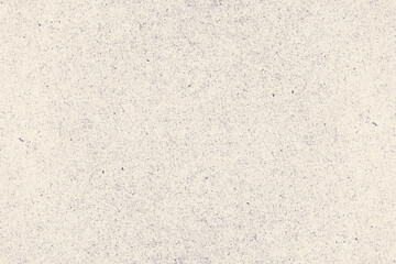 Worn and rough beige background with dots and specks of dust. Grunge texture of antique cardboard
