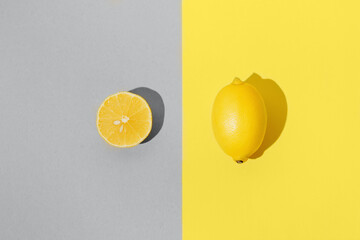 Creative layout made of fresh lemons on colorful background.
