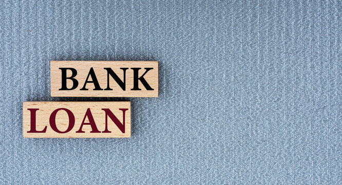 BANK LOAN - words on wooden bars on a gray background with a free space.