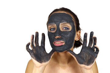 Beautiful girl with cosmetic mud mask shows her hands