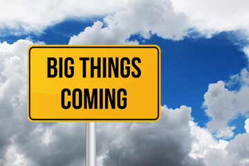 Big Things Coming in road sign, blue sky and white cloud