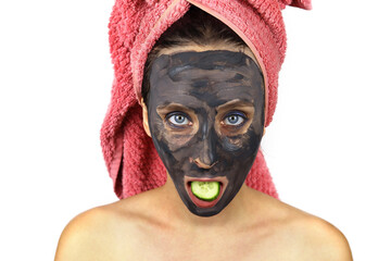 woman with a towel on head and a cosmetic mask on face. Spa treatments