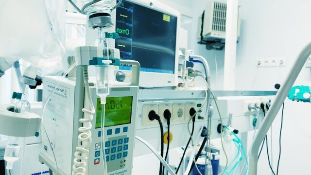 Heart rate monitor and Intravenous drip. Iv drip, infusion dripping to patient. Modern medical equipment in hospital room reanimation intensive care unit