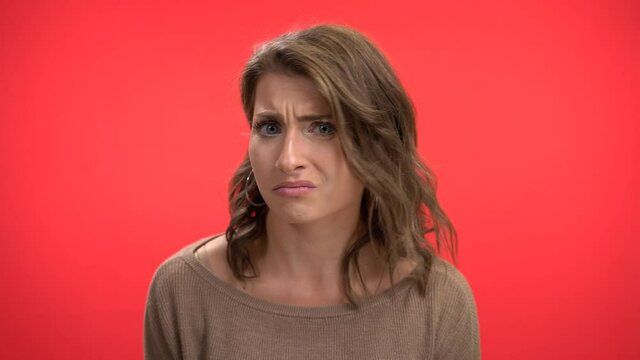 Beautiful woman confused by what someone is saying unconvinced doubtful