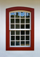 Colonial window on white facade