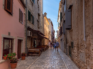 Fototapeta na wymiar Rovinj, Croatia - August 17 2019: Cobblestone street in the historic heart of Rovinj 
