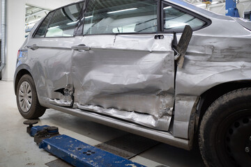 Fototapeta premium demolished car stands in a garage after an accident