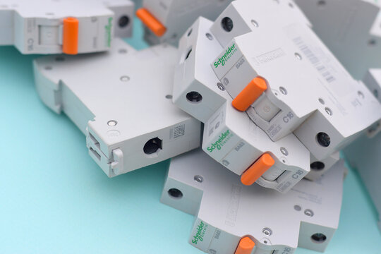 Schneider electric circuit breakers on light blue background. Schneider Electric is a French power engineering company, a manufacturer of electric equipment
