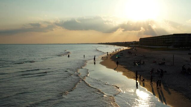 A hot summer sun sets over Folly Beach, South Carolina.