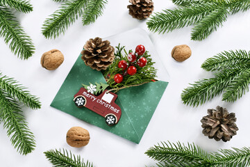 Fototapeta na wymiar Christmas decoration with envelope and greetings on car decor on white background