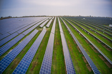 Fly over a renewable solar power plant with sun in Ukraine