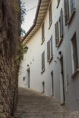 Beautiful narrow alley with upstairs in Brescia city. Historical architecture of the Lombardia region in Italy. Winter journey in North Italy. Travelling Europe. 