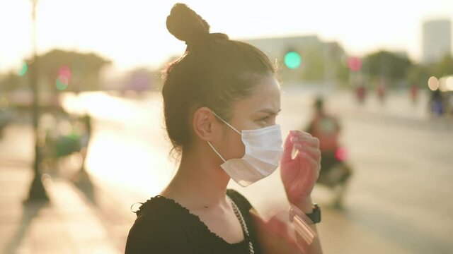Beautiful woman wearing a surgical mask outdoor, covid-19 , health and pollution concept.