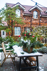 yard of a country house with New Year's decoration covered with snow