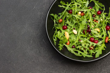 Fruit salad with arugula, tangerines and pomegranate seeds