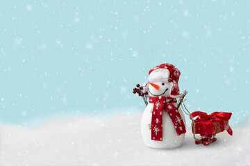 Happy snowman sledding gift box on sleigh in winter christmas landscape. Merry christmas and happy new year celebration concept
