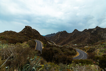 Cloudy mountainous landscape with a curvy road in Tenerife