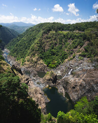 Barron Falls valley with lush rainforest and river flowing through 