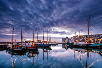 Urk village during sunset, Urk Flevoland Netherlands lighthouse and harbor lights during winter at...