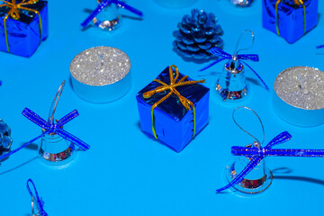 candles and christmas decorations on blue background, christmas festive background, blurred focus