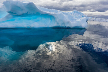 Fototapeta na wymiar Gentle waters surround Antarctica with large floating icebergs