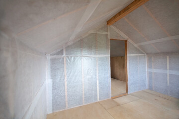 The walls of the frame house are sheathed with a vapor barrier membrane