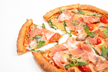 Pizza with prosciutto, cherry, arugula and basil isolated on white background