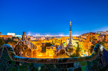 Fototapeta na wymiar Barcelona at night seen from Park Guell. Park was built from 1900 to 1914 and was officially opened as a public park in 1926. In 1984, UNESCO declared the park a World Heritage Site