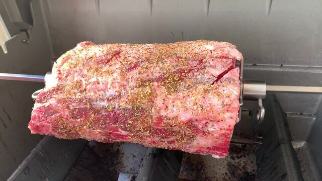 Rotisserie Beef Prime Rib Roast. Close Up Cooking Video.