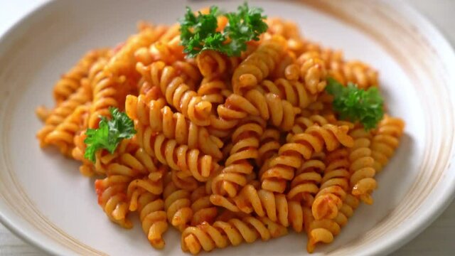 spiral or spirali pasta with tomato sauce and parsley - Italian food style