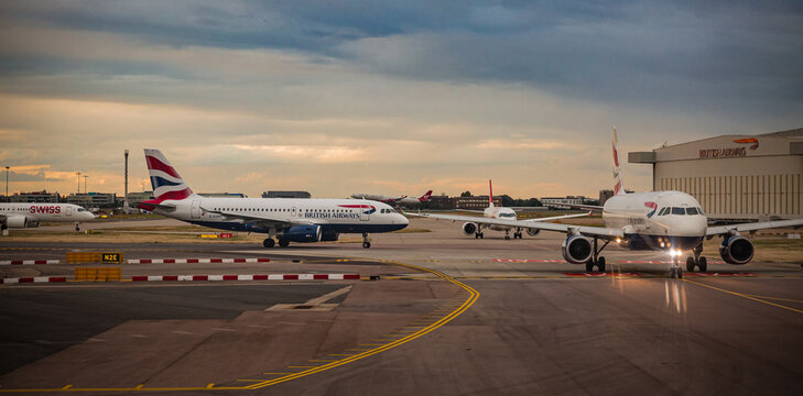 Heathrow, UK: Airplanes On The Runway At Sunset