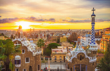 Beautiful sunrise in Barcelona seen from Park Guell. Park was built from 1900 to 1914 and was...