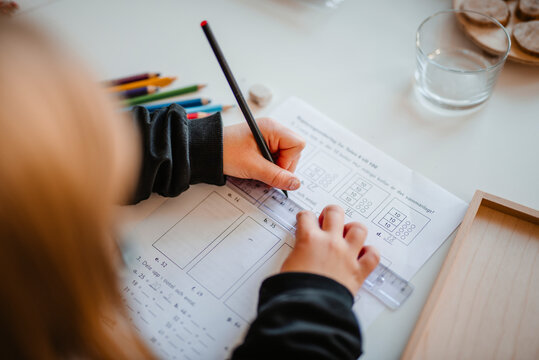 High angle view of girl doing homework