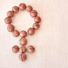 The gender symbol for the male body is made of macadamia nuts.