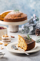 Traditional Christmas cake pudding with fruits and nuts with Christmas decorations, light background