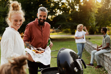 Friends having barbecue in park