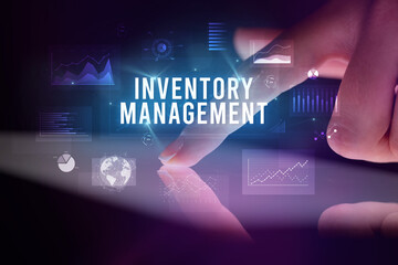Finger touching tablet with charts and INVENTORY MANAGEMENT inscription, business concept