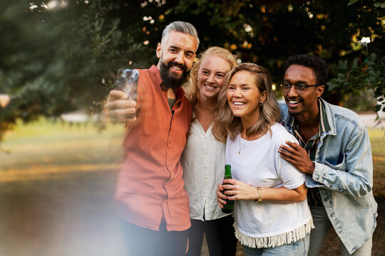 Smiling friends taking selfie - Powered by Adobe