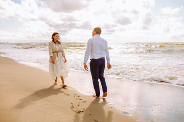 Happy just married middle age couple walk at beach and have fun on summer day