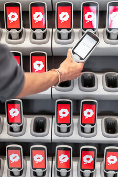 Mans hand holding barcode reader