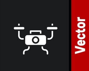 White Drone flying icon isolated on black background. Quadrocopter with video and photo camera symbol.  Vector.