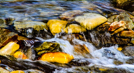 Fototapeta na wymiar Water rushing through the rocks on Bragg Creek. Bragg Creek Provincial Park, Alberta, Canada.