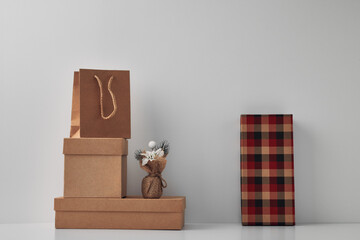 Gift boxes and packages on a light background and festive decor. Copy space, mock up.