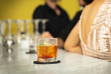 wisky on ice on the bar counter with blurry background