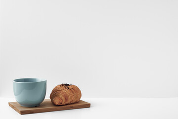Mug and croissants on a white background. Eco-friendly and natural materials in the decor, dessert. Copy space, mock up