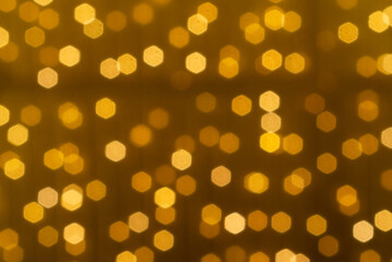 Abstract circular yellow bokeh in dark background, gold bubble.