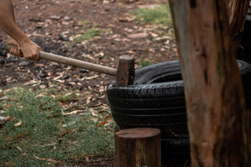 Obraz premium male hiting tires with sledgehammer closeup