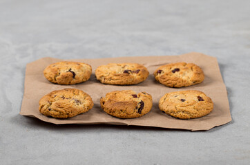 Vegan oatmeal cookies with dried cranberries on a light gray background
